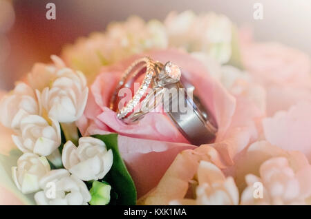 wedding rings on brides bouquet Stock Photo