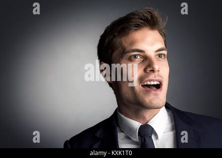 surprised caucasian businessman on gray background Stock Photo