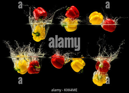 Group of bell pepper falling in water Stock Photo