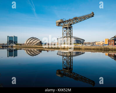 View of Finnieston Crane, SEC Armadillo and SEE Hydro arena beside River Clyde on blue sky winter day, Scotland, United Kingdom Stock Photo