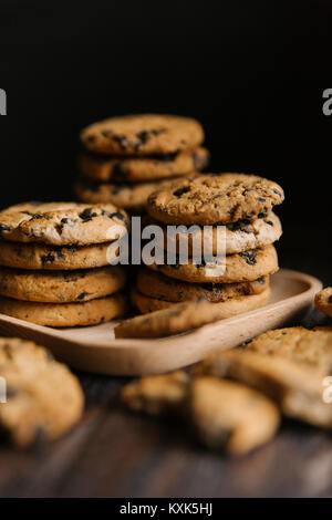 Close-up of cookies in tray on table against black background