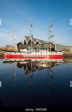 View of Riverside Museum beside River Clyde home of Glasgow Transport Museum with Glenlee ship moored in front in Glasgow, United Kingdom Stock Photo