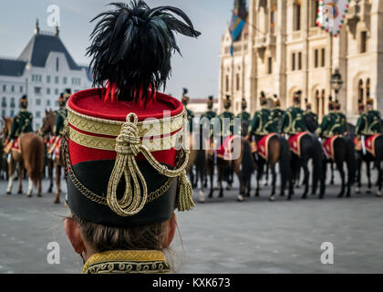 Hussar traditional military hat closeup. Background with line up of hussar cavalry on horses,military parade in Budapest, Hungary, 15 March. Stock Photo