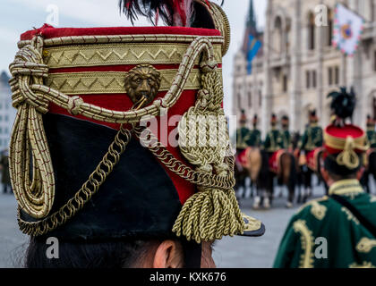 Hussar traditional military hat closeup. Background with line up of hussar cavalry on horses,military parade in Budapest, Hungary, 15 March. Stock Photo