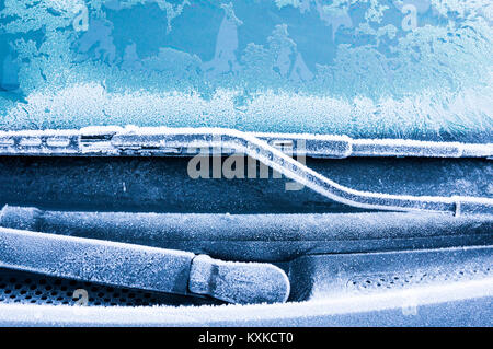 Iceflowers, frozen.The ice-cold frost forms ice crystals in beautiful unique patterns on the window, Hood and wiper on the Car Stock Photo