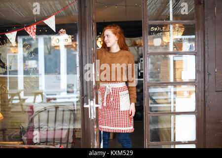 Portrait of small business owner in cafe doorway Stock Photo