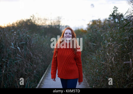 Portrait of young woman walking along rural pathway Stock Photo