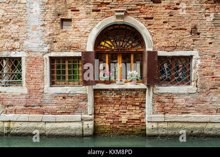 Building facade detail along a small canal in Veneto, Venice, Italy, Europe. Stock Photo