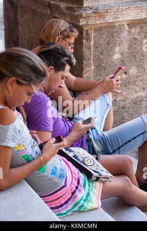 Cubans using smartphones in Havana, Cuba. Stock Photo