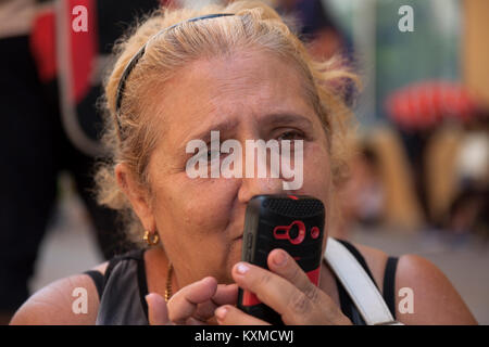 A Cuban woman makes a phone call on her cell phone in Havana, Cuba. Stock Photo