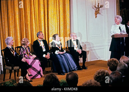 First lady Barbara Bush makes remarks during a ceremony for 1989 Kennedy Center Honorees in the East Room of the White House, December 3, 1989 in Washington, DC. The 1989 honorees are, from left to right: actress and singer Mary Martin, dancer Alexandra Danilova, singer and actor Harry Belafonte, actress Claudette Colbert, and composer William Schuman. Credit: Peter Heimsath / Pool via CNP /MediaPunch