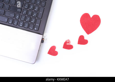 Red heart with laptop on wooden table Stock Photo