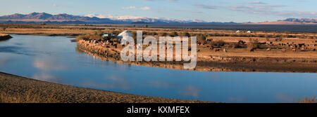 Sunset river Mongolia landscape plains grasslands steppes goats herd ger golden hour Stock Photo