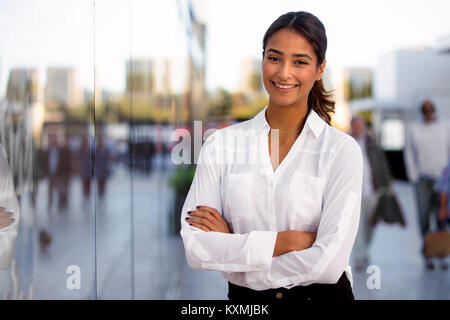 Beautiful female executive modern business woman walking to work at office building Stock Photo