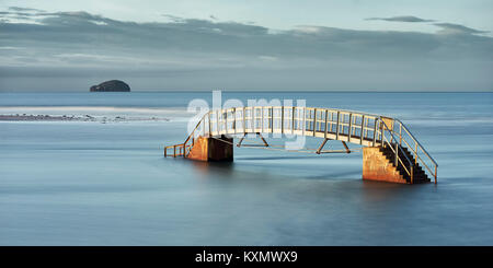 The 'Bridge to Nowhere, Belhaven Bay, Dunbar, East Lothian, Scotland. At high tide with the Bass Rock in the distance Stock Photo