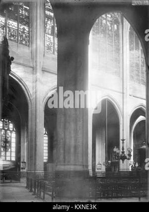 The photograph captures a diagonal view of the nave of the Church of Saint-Gervais-Saint-Protais in Paris, highlighting its architectural features. The image is part of the Médiathèque de l'architecture et du patrimoine collection. Stock Photo