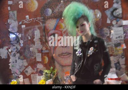London, UK. 10th Jan, 2018. 10th of January 7pm David Bowie mural Brixton London UK , fans pay homage to the late siger songwriter with a candle lit vigil and a singalong in memorium of the late actor ,pop star and singer who passed away 2 year ago Credit: Philip Robins/Alamy Live News Stock Photo