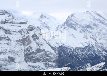 Wengen, Switzerland. 11th Jan, 2018. A commercial airplane flies in front of The Silberhorn mountains during a foggy day in the ski resort of Wengen in the Swiss Alps, Credit: amer ghazzal/Alamy Live News Stock Photo