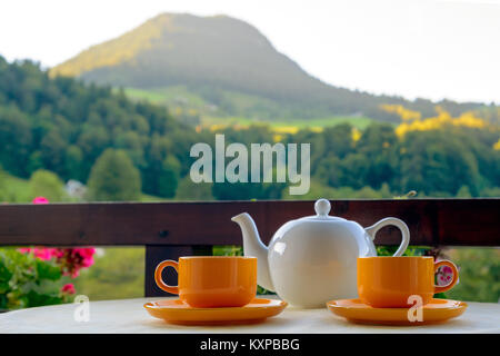 Teapot and two cups on mountain resort  terrace Stock Photo