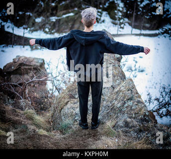 Young man on cliff edge Stock Photo