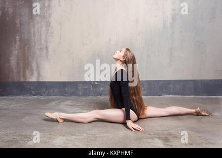 Cheerful long haired female dancer enjoying the warm up. Studio shot Stock Photo