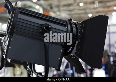 Spotlight with barn doors in the film studio. Stock Photo