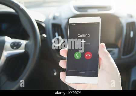 Man using phone calling system in car. Hand-free safety driving. Stock Photo