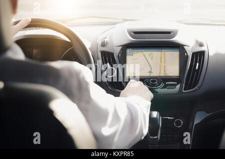 GPS navigation system. Person driving a car with satellite navigation. Stock Photo