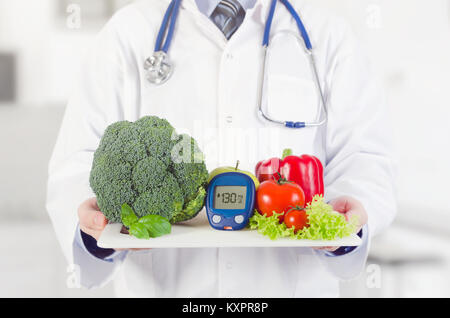 Doctor holding vegetables and fruits on a tray. Diet, nutrition, health care for diabetes concept Stock Photo