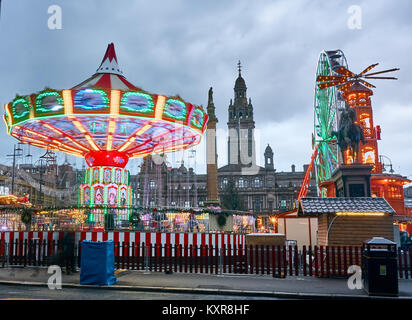 Christmas fair with carousels and other attractions on George Square in Glasgow city, Scotland. Stock Photo