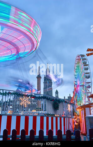 Christmas fair with carousels spinning on George Square in Glasgow city, Scotland. Stock Photo