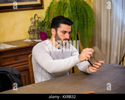 Concentrated man playing with tablet Stock Photo