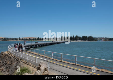 Victor Harbor pier in South Australia is a causeway to Granite Island built for horse drawn trams to service large American and European clippers. Stock Photo