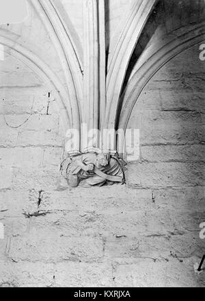 A detailed image of a sculpted console featuring a human figure from the donjon of Château de Vincennes, highlighting Gothic architectural ornamentation and craftsmanship. Stock Photo