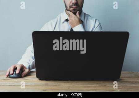 Young adult caucasian businessman working on laptop. Stock Photo