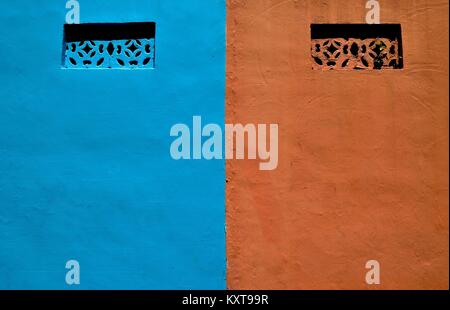Old blue and brown wall with traditional ventilation ducts showing rich texture and tones Stock Photo