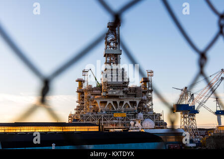 Haugesund, Norway - December 9, 2018: Johan Sverdrup drilling platform at Risoya in Haugesund. Protected behind mesh fencing. Stock Photo