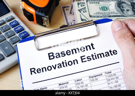 Clipboard with calculations basement renovation estimate. Remodel budget. Stock Photo