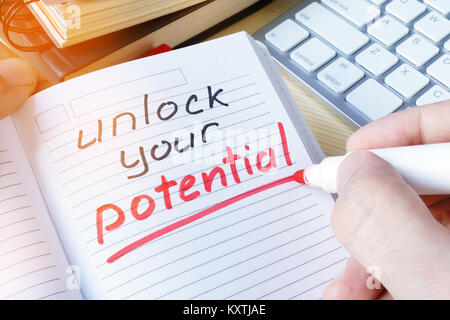 Man writing quote Unlock your potential. Stock Photo