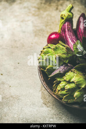 Flat-lay of green and purple vegetables on plate, copy space Stock Photo