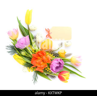 Colorful tulips with easter eggs on white background. Top view. Stock Photo
