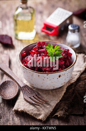 Bowl of beetroot salad on wooden background Stock Photo