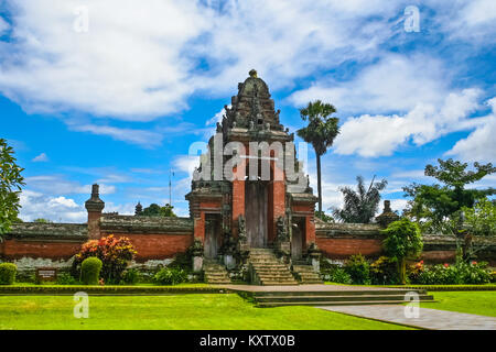 A roofed tower gate (kori agung), which is the entrance to the temple's inner sanctum of Pura Taman Ayun in Mengwi, Bali, Indonesia. Stock Photo