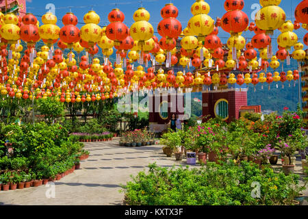 The garden of the Kek Lok Si Temple, decorated with red and yellow Chinese paper lanterns during the Spring Festival. Stock Photo
