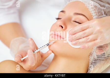 A woman receives an inejection on her face. Stock Photo