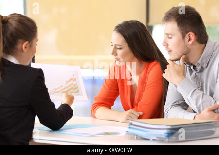 Three businesspeople analyzing a growth graph at office Stock Photo