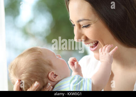 Close up portrait of a happy mother looking at her newborn baby