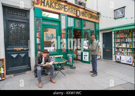 Shakespeare And Company Paris, view of two men browsing books outside the famous Shakespeare And Company bookshop in the Left Bank of Paris, France. Stock Photo