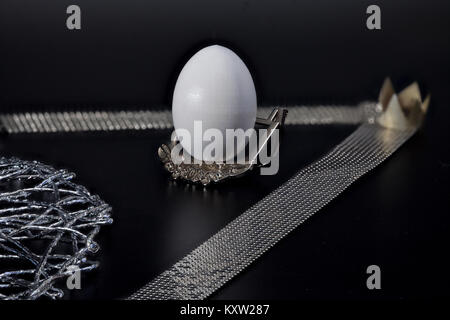 white egg on a silver stand royal award, black background Stock Photo