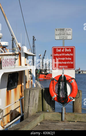 Warning signs at the end of dock at wharf in New Bedford Harbor, Massachusetts Stock Photo